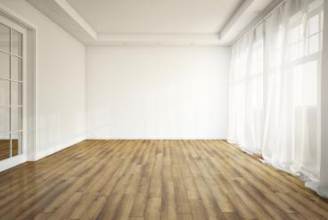 empty room with laminate flooring and white curtains